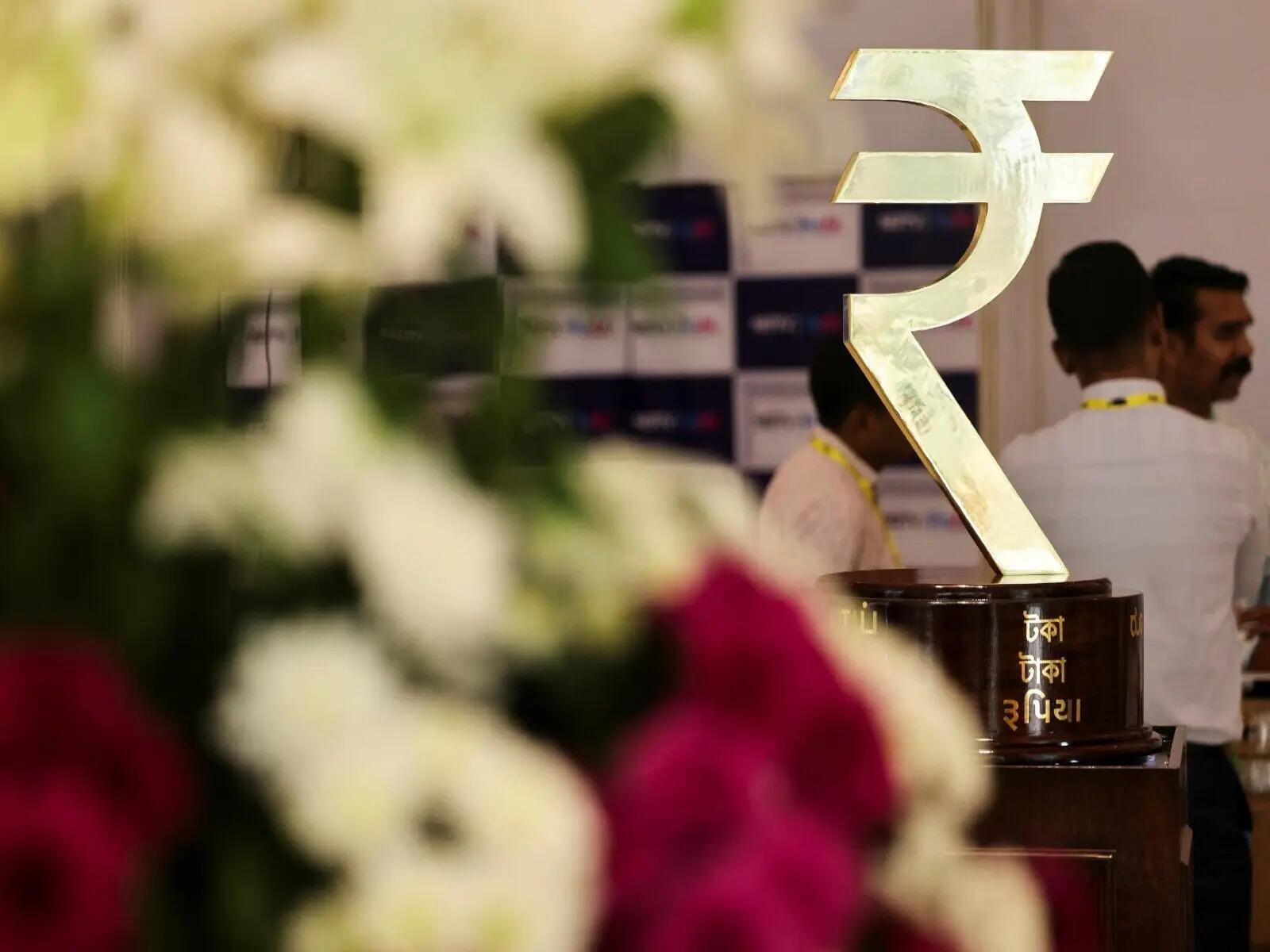 Rupee ends nearly flat, likely RBI presence blunts hit from higher oil prices