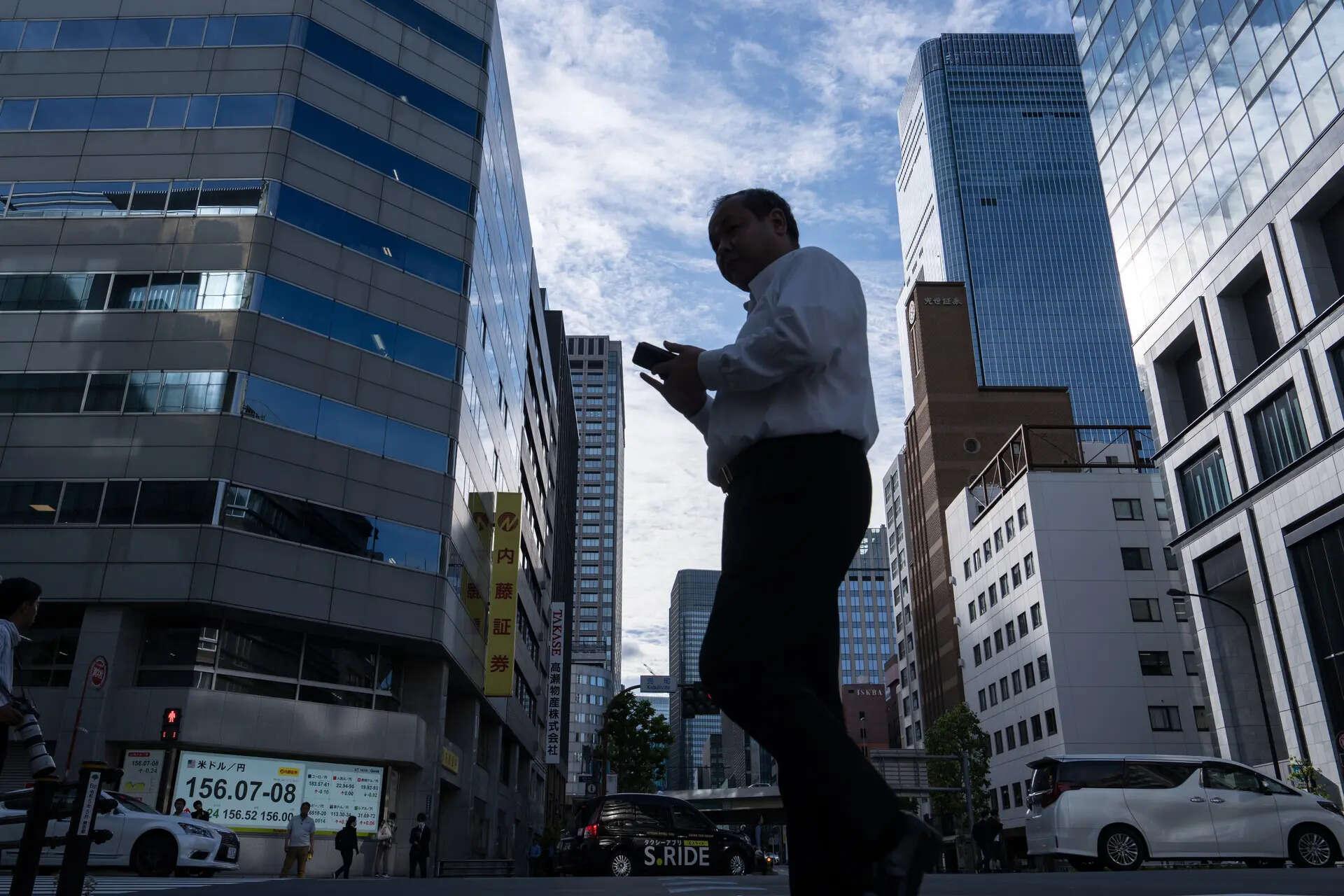 Japan's Nikkei touches record high on tech optimism; SoftBank, Topix slump