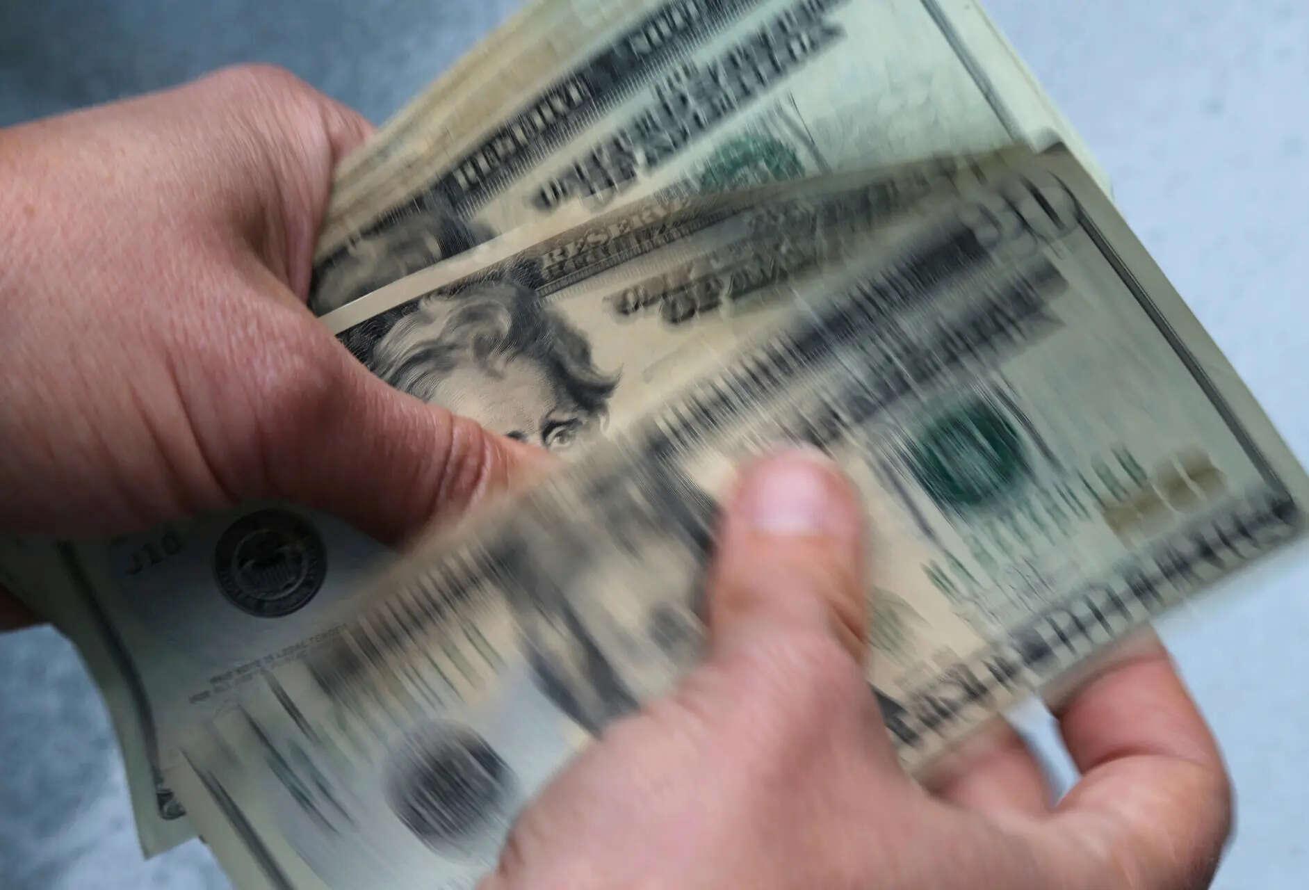 Dollar jumps as Fed holds rates but projects one hike later this year